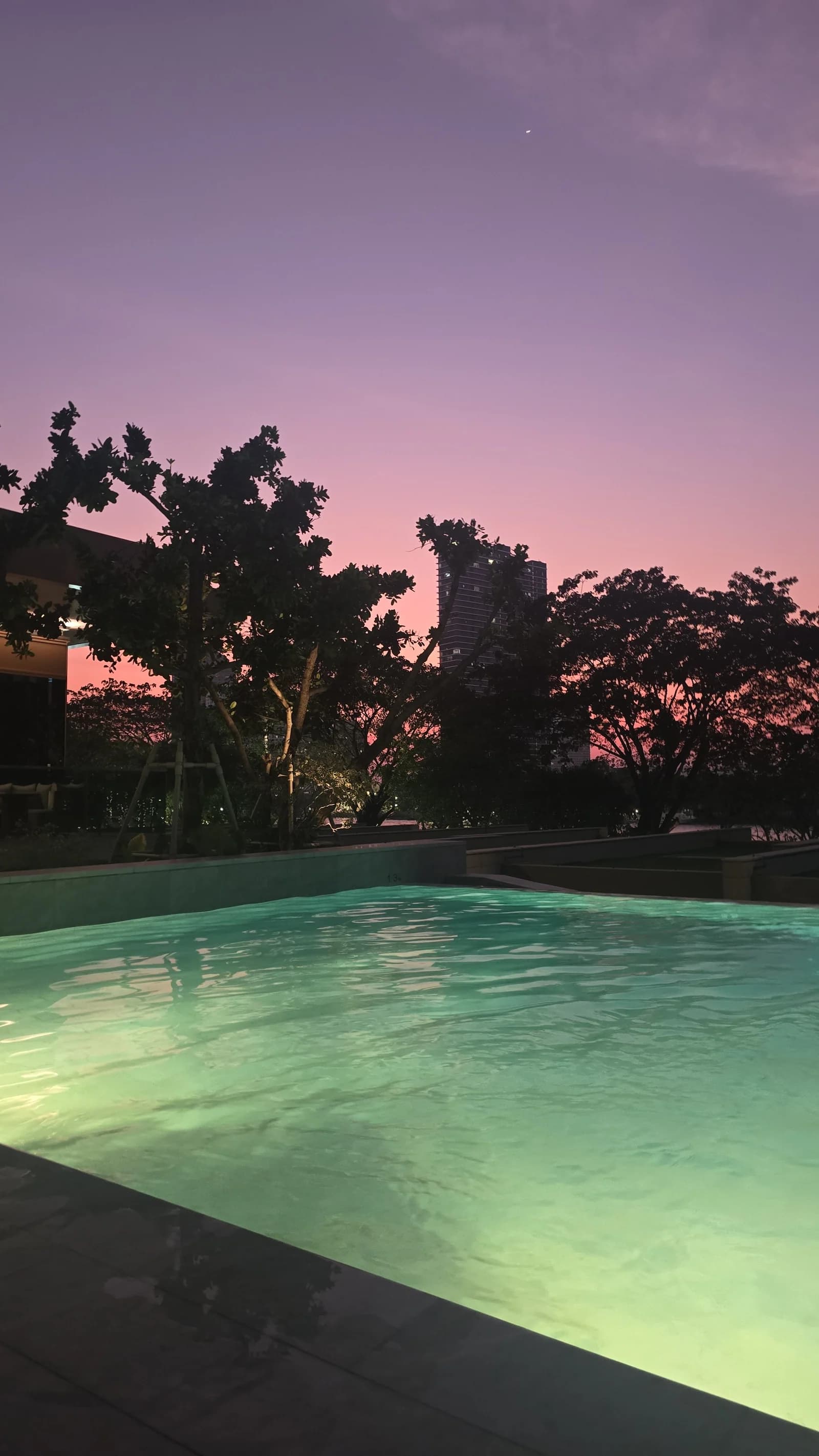 Quiet dusk pool atmosphere at Capella Bangkok by the river