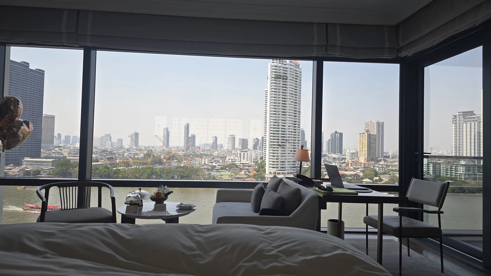 Riverfront Premier Room bed facing the Chao Phraya River at Capella Bangkok