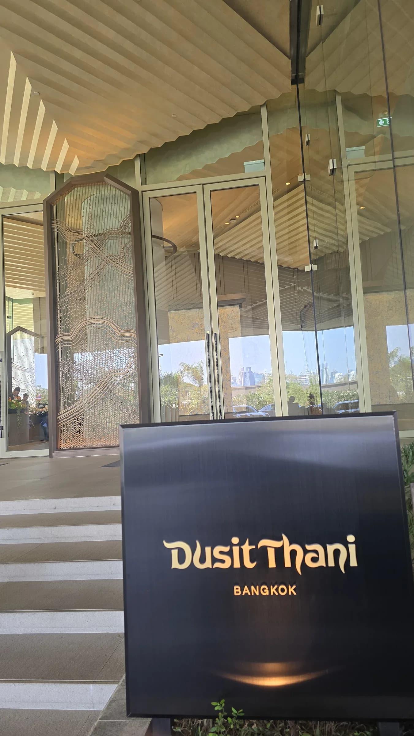 The arrival sign is included to anchor the stay photography at Dusit Thani Bangkok.