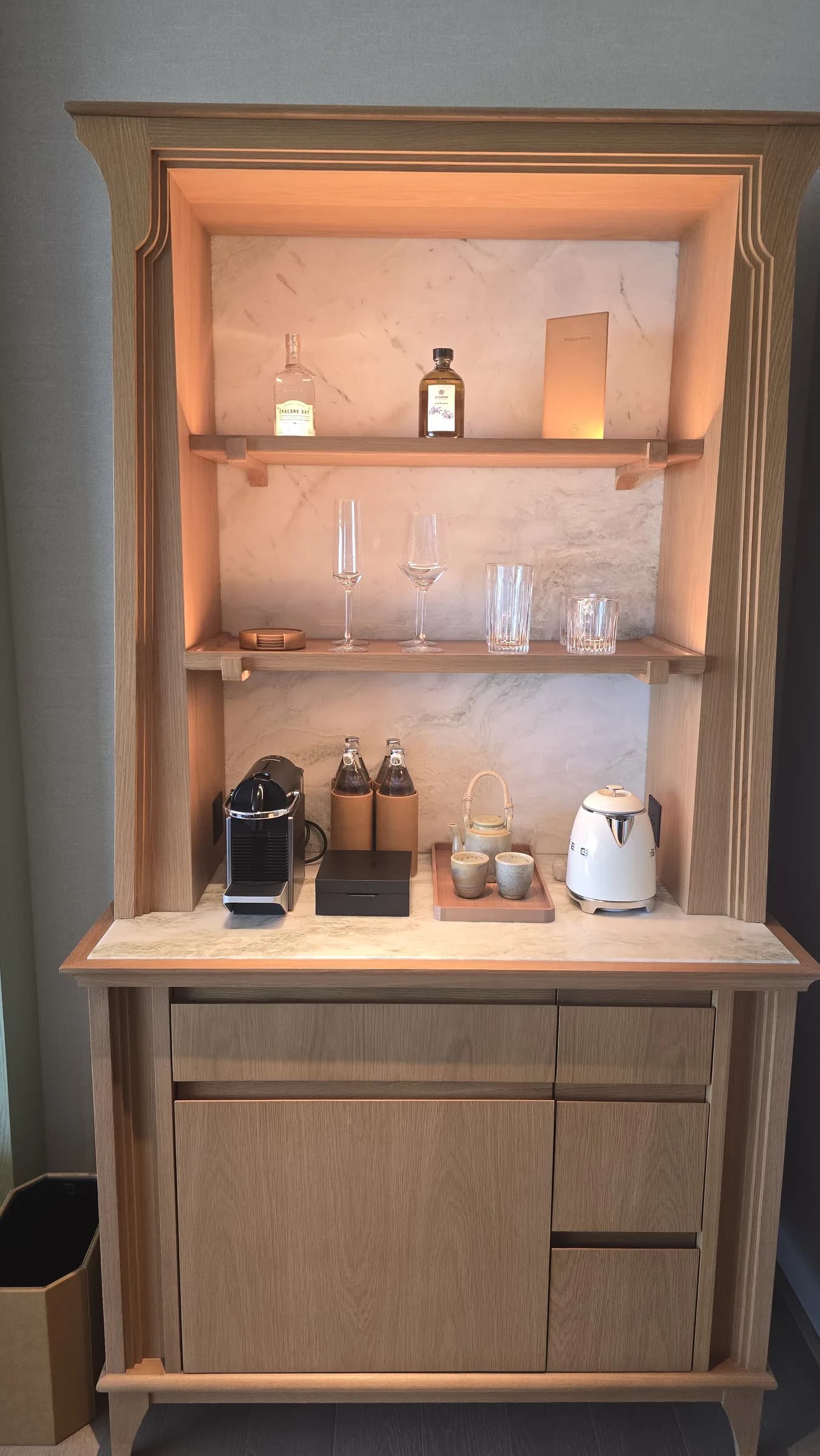The minibar and storage zone show how neatly the room handled small daily-use functions.
