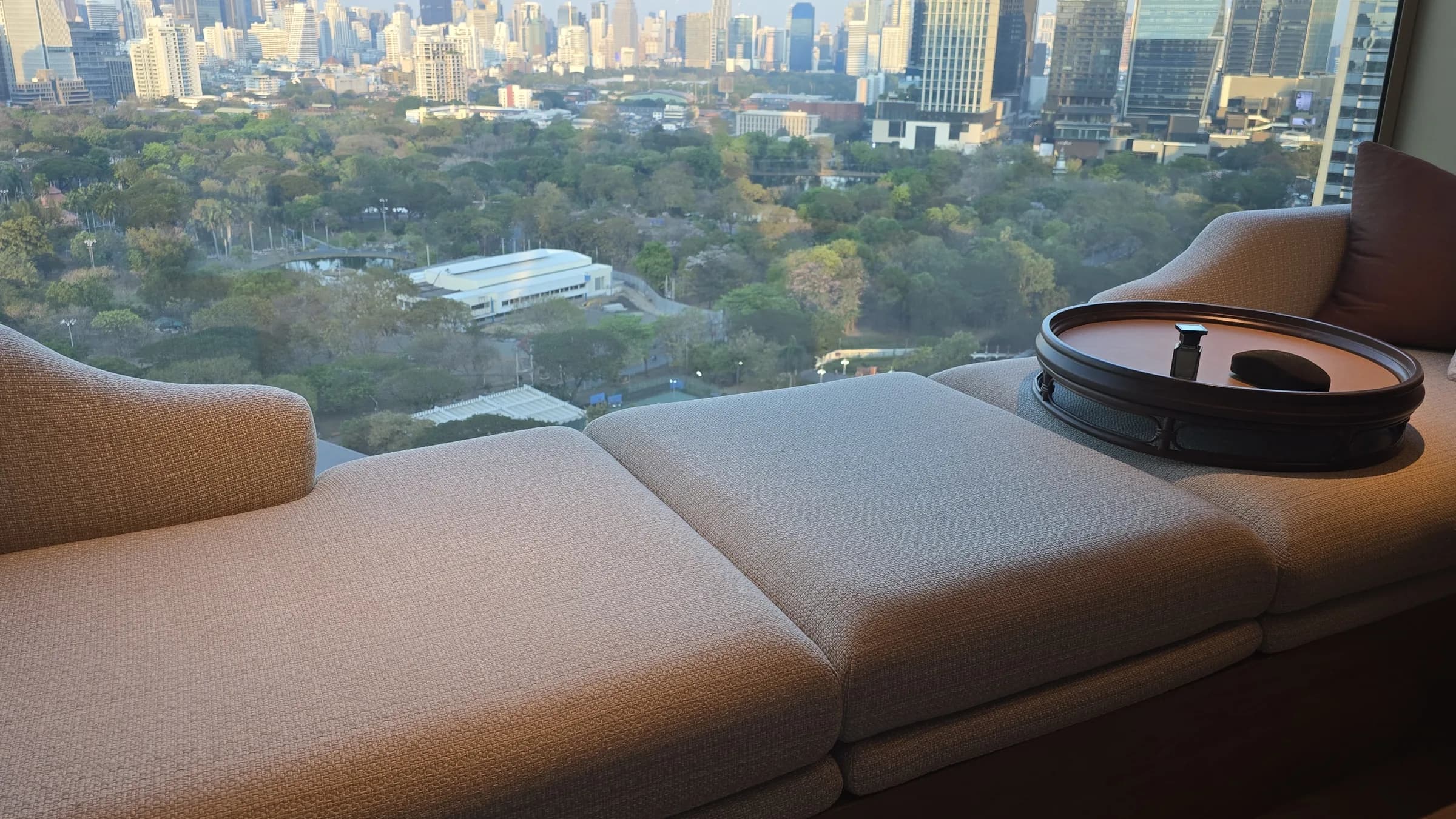 The bay-window seat turns the park view into usable room time, not just a background view.