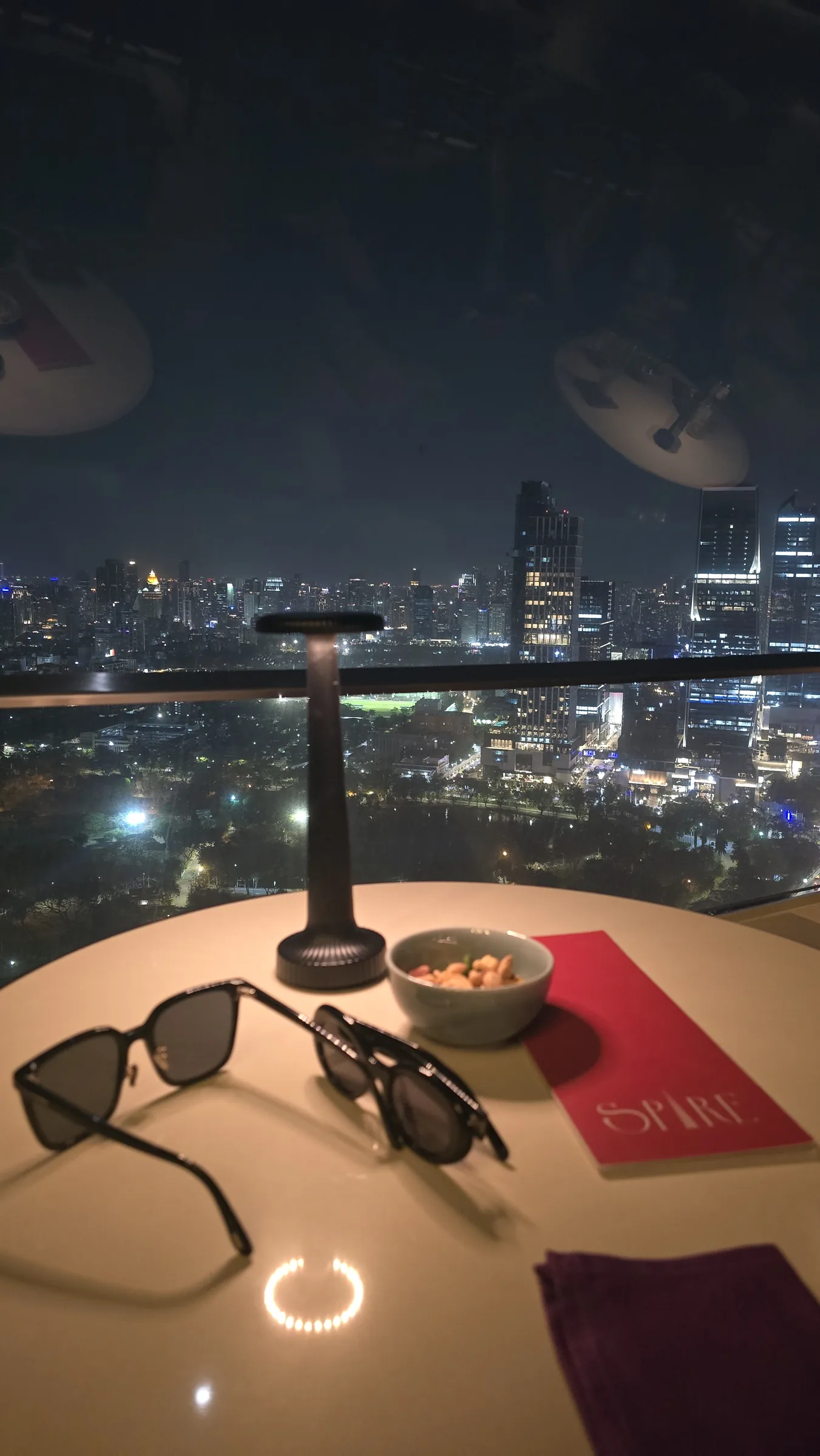 The table-side city view explains why the rooftop became a second scene in the stay.