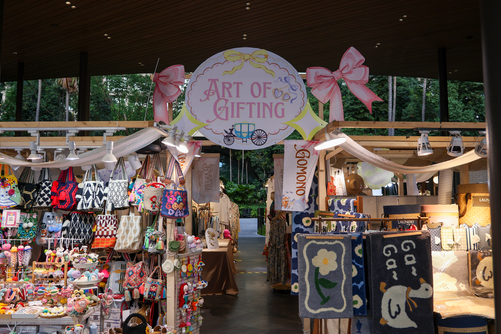 บูธ ART OF GIFTING ที่มีกระเป๋า ของชิ้นเล็ก และเสื่อหลายลาย
